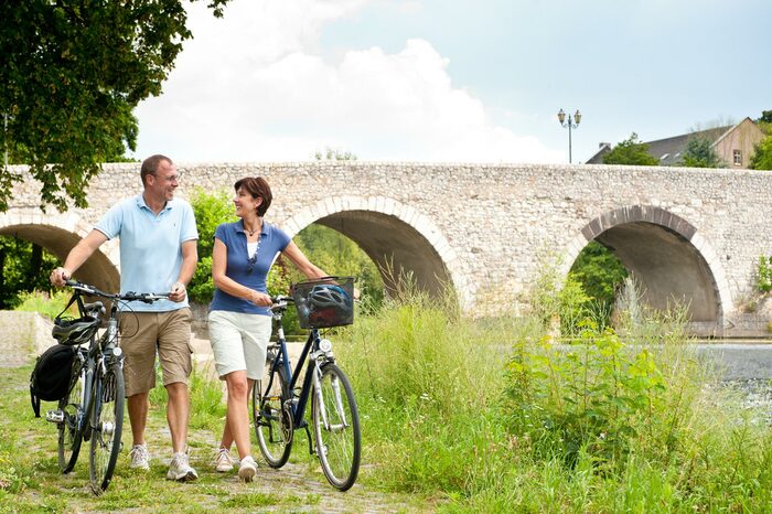 Radfahrer schieben Ihrer Räder an der Lahn entlang